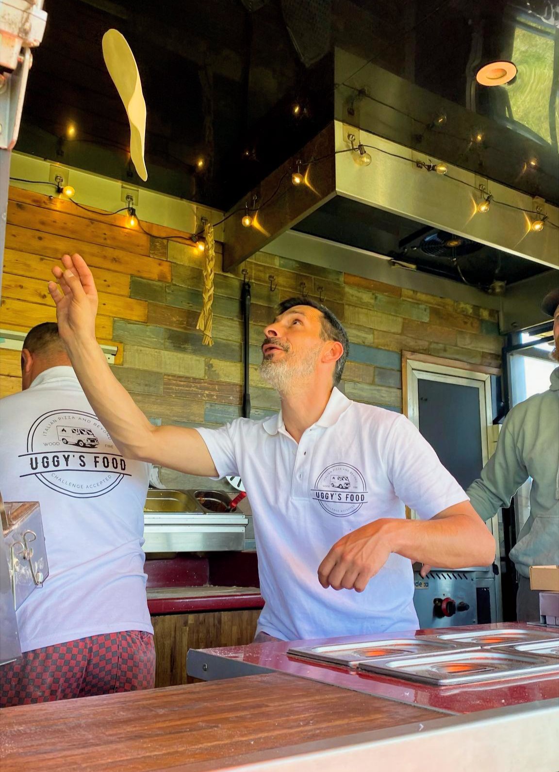 Our chef tossing pizza dough